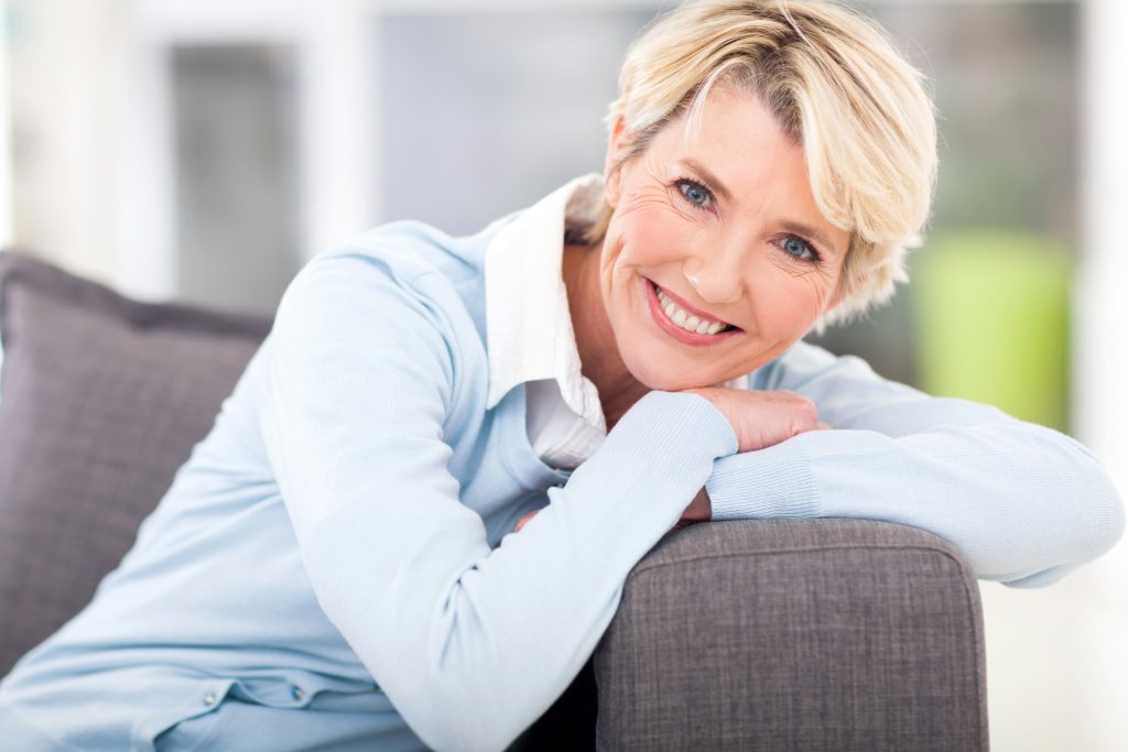 Lady Smiling While Sitting on Couch