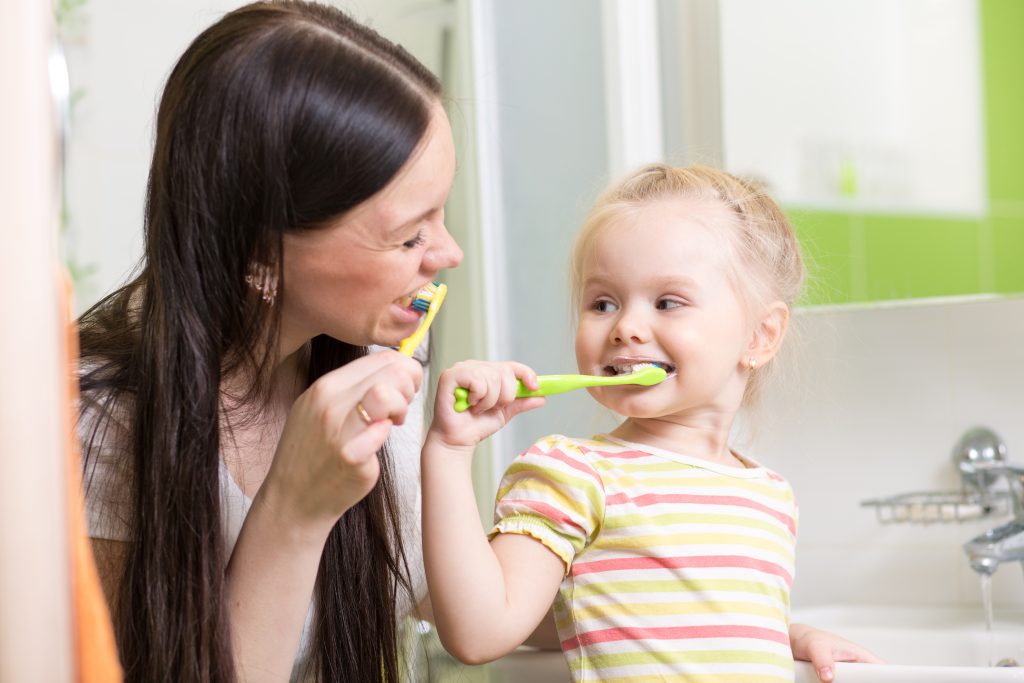 Mom and Daughter Brushing Their Teeth